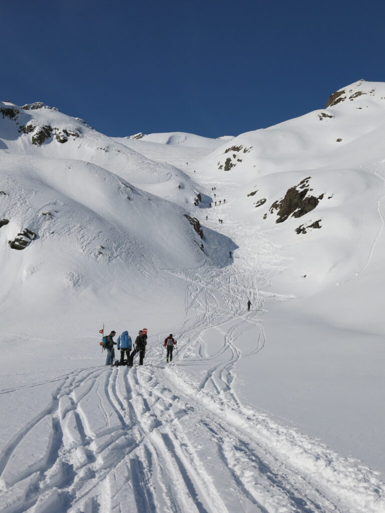 People skiing in spring snowpack in the Ortler, illustrating human factors