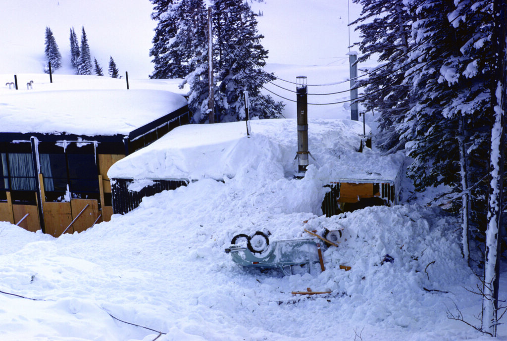 The Alta lodge and a VW covered in avalanche debris.